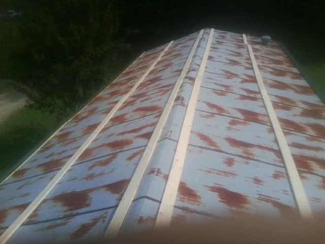Rusted metal roof panels with new wood purlins before replacement — Storm Damage Roof Repair in Bandon by Roofing Brothers